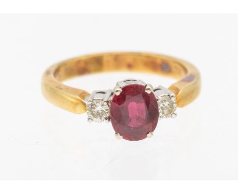 A ruby and diamond 18ct gold ring, comprising an oval mixed cut ruby approx 7x5mm, claw set in white gold, with a single roun