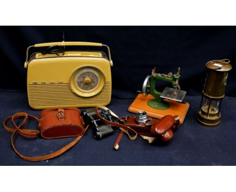  A modern vintage radio, a mid 20th Century child's sewing machine, vintage cameras, miners lamp with binoculars.