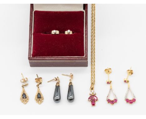 A ruby and diamond 9ct gold pendant and chain, comprising three pear cut rubies with three round brilliant cut diamonds set t