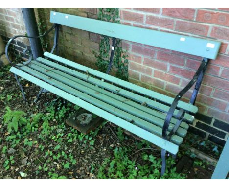 A mid 20th Century cast and wooden garden bench, cast swirl arms and support, olive green.
