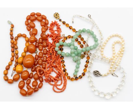 A collection of various vintage and later bead necklaces to include Bakelite and amber type necklaces, a faux pearl strand, a