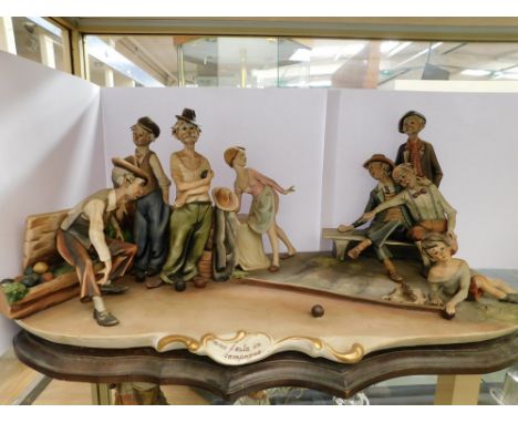 An unusual and seldom seen large Capo De Monte sculpture of old men playing bowls, signed by Sculptor., minor nibble to rim