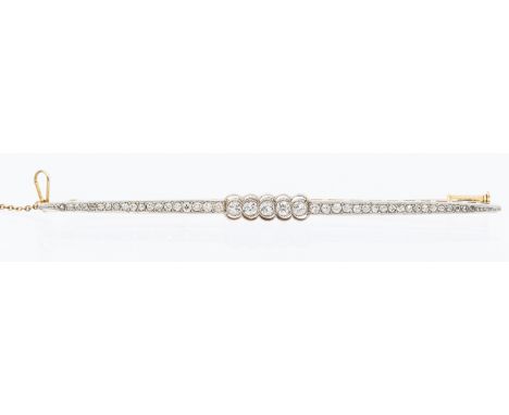 An Edwardian diamond set gold bar brooch, comprising a platinum set top, set centrally with a row of five old European cut di