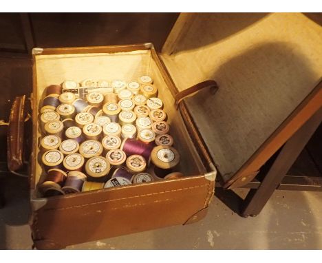 Vintage suitcase containing approximately sixty cotton reels