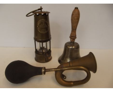 Brass car horn, a miners lamp and a school bell