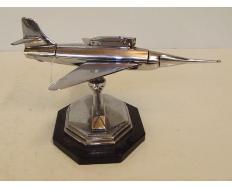 1960's table lighter in the form of a jet fighter, height 10cm, wingspan 17cm, slight damage to elevator wing