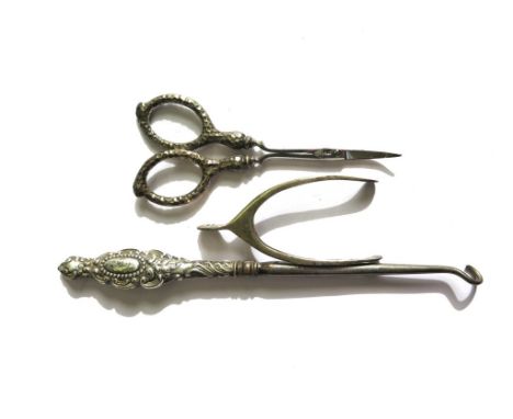A silver handled button hook and scissors and a silver wish bone pair of sugar tongs