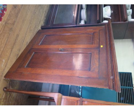 An oak corner cupboard, with twin panelled doors enclosing a shelf 86cm wide 87cm high
