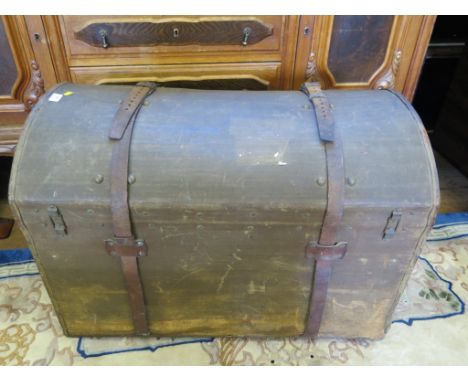 A canvas domed trunk with leather sraps, 85cm wide, 60cm high and an Edwardian wall mirror (2)