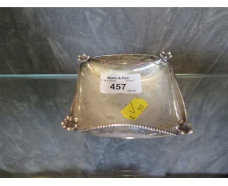 A small cushion shaped silver dish on four feet
