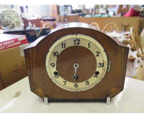 A 1930's walnut mantel clock, with sunburst inlay, three train movement striking on gongs