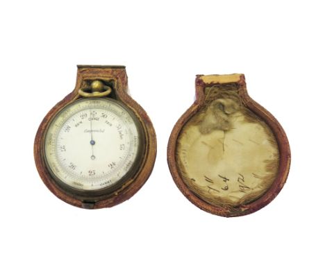 A brass barometer in leatherette case, 5cm diameter