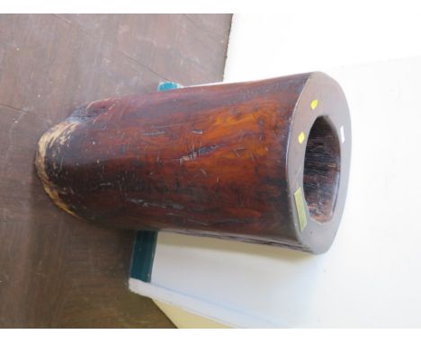A hollowed elm trunk, now used as an umbrella stand, with plaque inscribed 'This elm trunk cut from a 10 feet length formed p