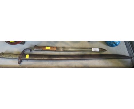 A French bayonet, the blade inscribed d'Ormes de St Etienne 8bre 1873, the metal scabbard numbered 335579, blade 57.5cm long,