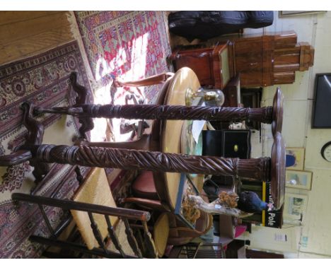 A pair of mahogany torchere stands, with foliate carved spiral stem and tripod bases