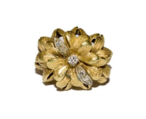 An 18 carat gold dress ring simulating flower heads with diamonds