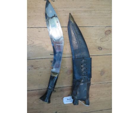 A horn handled Kukri with two sharpening blades and leather scabbard