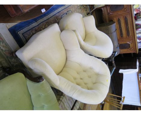 An Edwardian button back armchair, with turned legs and castors, and another tub armchair in similar upholstery (2)