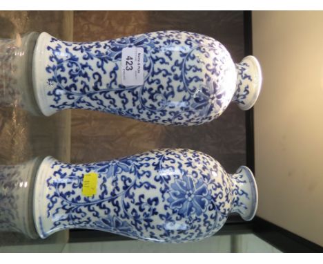 A pair of blue and white Chinese baluster vases, with all over foliate scroll design, four character mark 23cm high