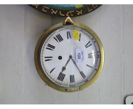 A brass ship's clock, with enamel dial and single train movement 18.5cm diameter