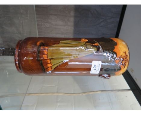 A Royal Doulton cylindrical vase, depicting a witch playing a recorder designed by Charles Noke, 27cm high