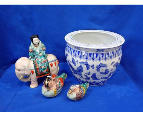A ORIENTAL STYLE JARDINERE WITH A CERAMIC WOMAN RIDING AN ELEPHANT with two ceramic oriental ducks 