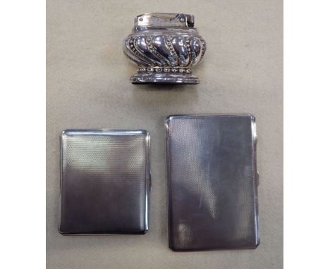 TWO SILVER CIGARETTE CASES and a plated table lighter