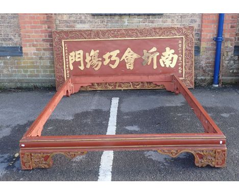 A CHINESE CARVED PAINTED AND GILTWOOD BED FRAME BASE, AND SIMILAR HEADBOARD with gilt script to the centre, the head panel 10