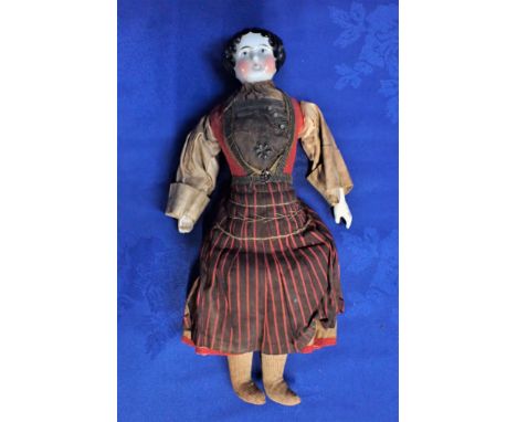 A 19TH CENTURY GERMAN PORCELAIN HEAD DOLL with ceramic hands, and cloth legs, with probably original peasant style clothing, 