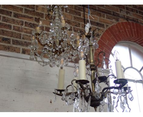 A GILT-METAL AND CUT-GLASS SIX-LIGHT CHANDELIER 20th century, with a glass stem, and scrolling branches, 52cm high 53cm wide,