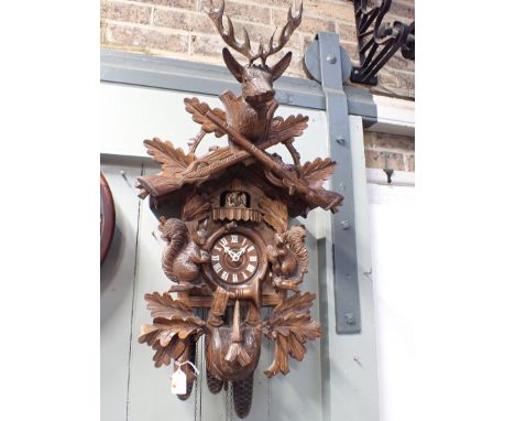 A THREE-TRAIN REUGE CUCKOO CLOCK, WITH REVOLVING FIGURES AND MUSICAL MOVEMENT (playing Eidelweiss and Lara's Theme) the movem