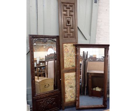 A CARVED OAK FRAMED WALL MIRROR 20th century, the bottom panel carved in relief with an Ionic capital, 169cm high x 63cm wide