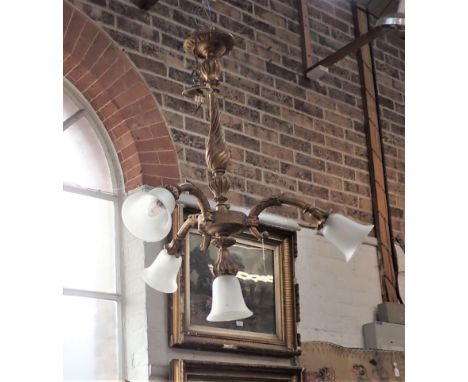 A ITALIANATE GILTWOOD CEILING LIGHT with a turned central column, and frosted shades, 87cm high x 82cm across (approx) (evide