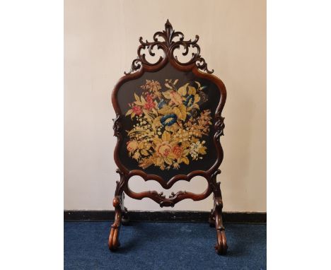A Victorian rosewood glass and tapestry front firescreen on two scrolled supports and oak leaf carving to top. IMPORTANT: Onl