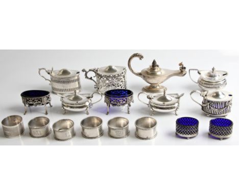 Six hallmarked silver napkin rings (one set of three, a pair and one single), a hallmarked silver table lighter in the shape 