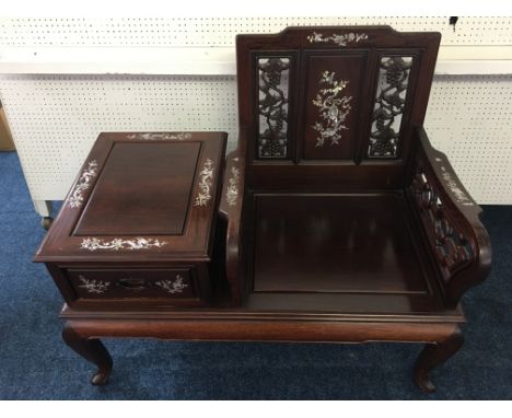 *A Chinese style hardwood telephone hall seat with carved pierced back and sides with mother of Pearl dragon and lotus design