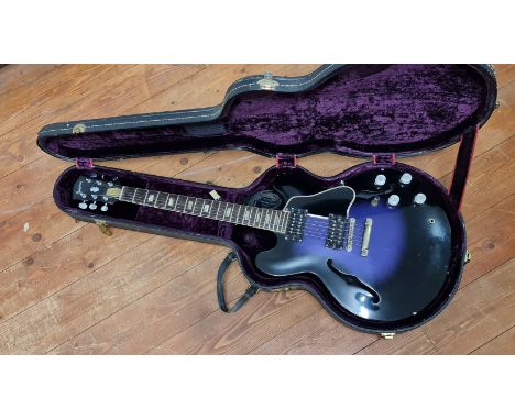 A Gibson ES 1970s vintage guitar, resprayed black and purple and had repair to head, in hard case. IMPORTANT: Online viewing 