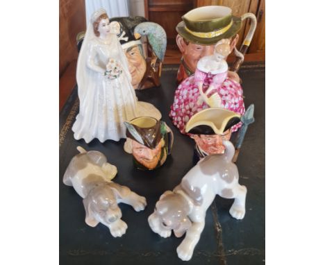 A Royal Worcester Queen Elizabeth II figurine and a Royal Doulton figurine with signature to base, two Lladro dog figurines, 