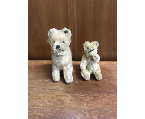 Two early Steiff stuffed animals, a dog and a bear, with buttons in ear, approx height 10cm and 7cm.