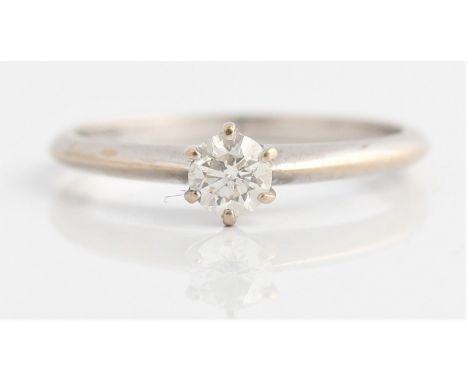 A hallmarked 18ct white gold diamond solitaire ring, set with a central round brilliant cut diamond, measuring approx. 0.25ct