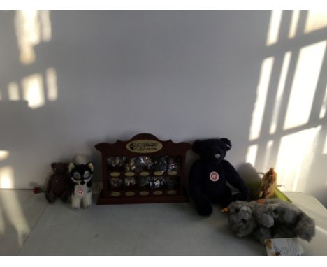 A collection of Steiff club items to include Camel on a pin cushion in a box, a toy cat, a toy dog, a teddy bear a collection