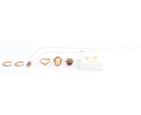 Three hallmarked 9ct yellow gold rings, a cameo ring size M½, a wishbone ring size M½, and a red paste cluster ring, along wi