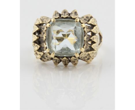 A single stone aquamarine ring, set with a central cushion cut aquamarine, measuring approx. 10mm, surrounded by open metalwo