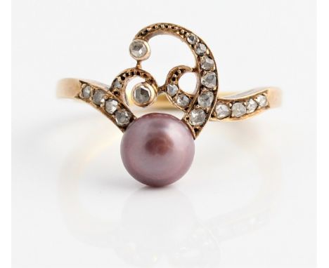 An Art Nouveau style pearl and diamond ring, set with a pinkish purple button pearl, measuring approx. 6mm, set to scrolling 