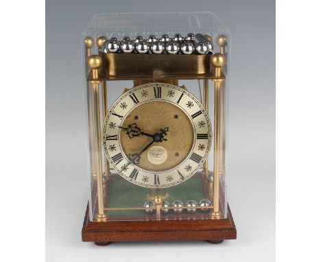 A late 20th century brass rolling spherical ball weight clock timepiece by Thwaites &amp; Reed, with platform escapement, the