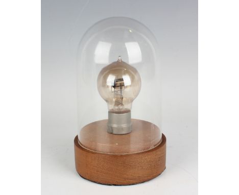 A Marconi valve light bulb, detailed 'R 7308', height 9.7cm, on a wood plinth with Perspex dome cover.Buyer’s Premium 29.4% (