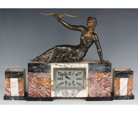 An Art Deco marble and spelter mantel clock garniture, the clock with French eight day movement striking on a belle via an ou