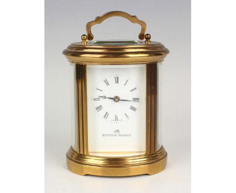 A late 20th century gilt brass oval cased carriage timepiece with eight day movement, the white enamel dial with Roman hour n