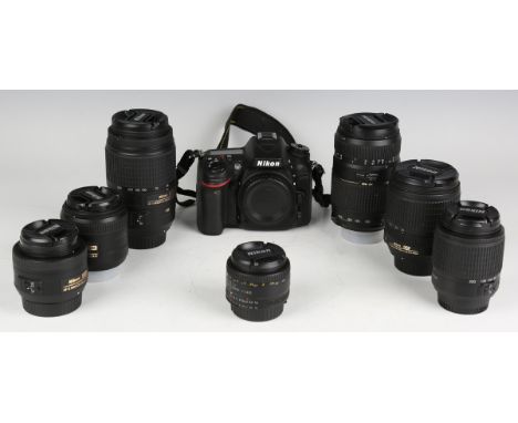 A Nikon D7100 camera body and a small group of Nikon lenses, comprising Nikkor 18-105mm 1:3.5-5.6 zoom lens, Nikkor 55-300mm 