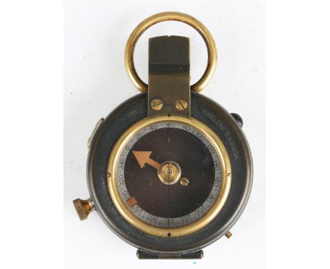 A First World War period oxidized brass cased pocket compass, detailed 'No. 71752' and dated '1917', case diameter 5.5cm, lea